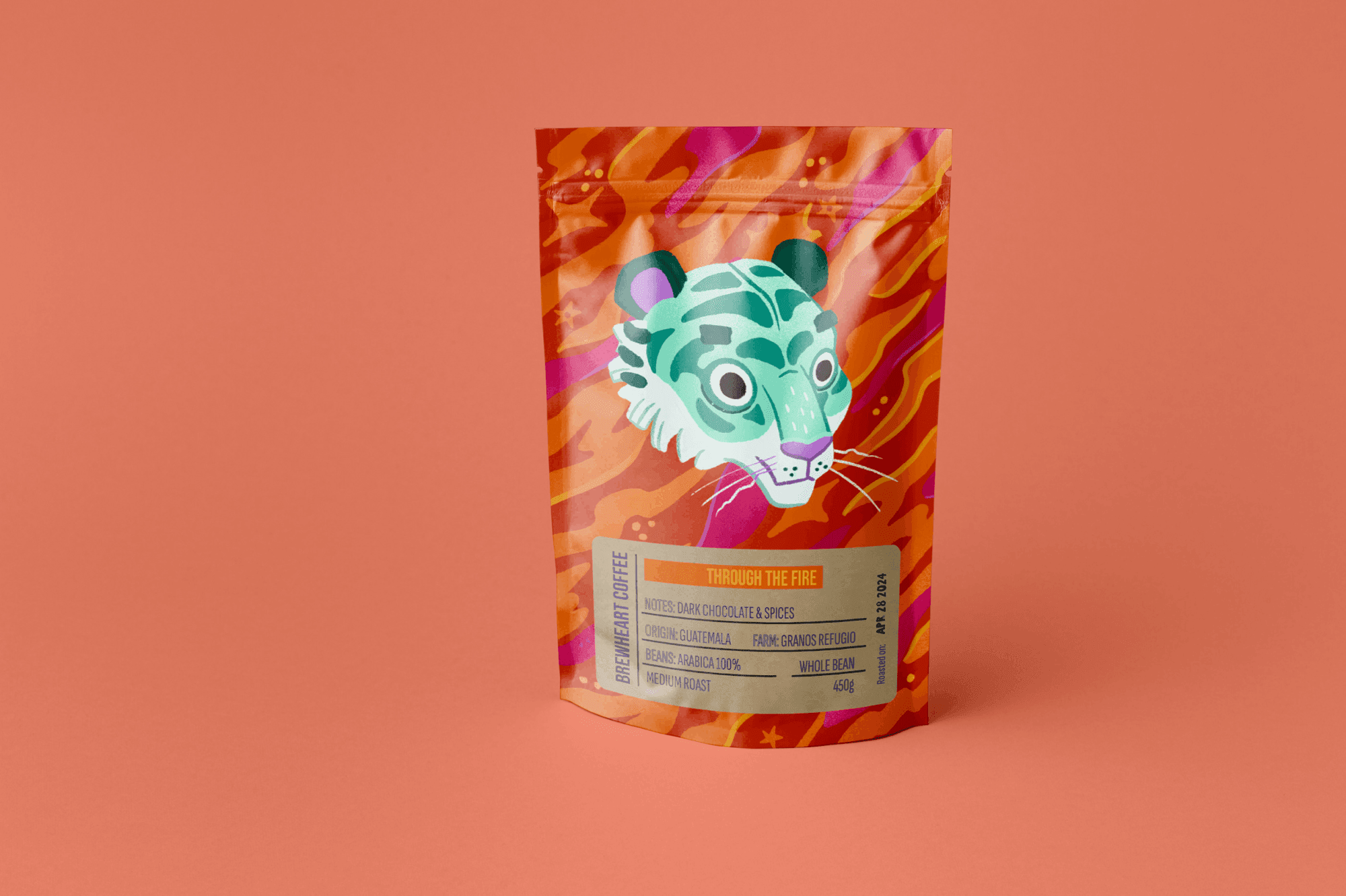 A colorful coffee bag with an illustrated tiger face on it, featuring teal and purple hues and a vibrant orange, pink, and purple background pattern.