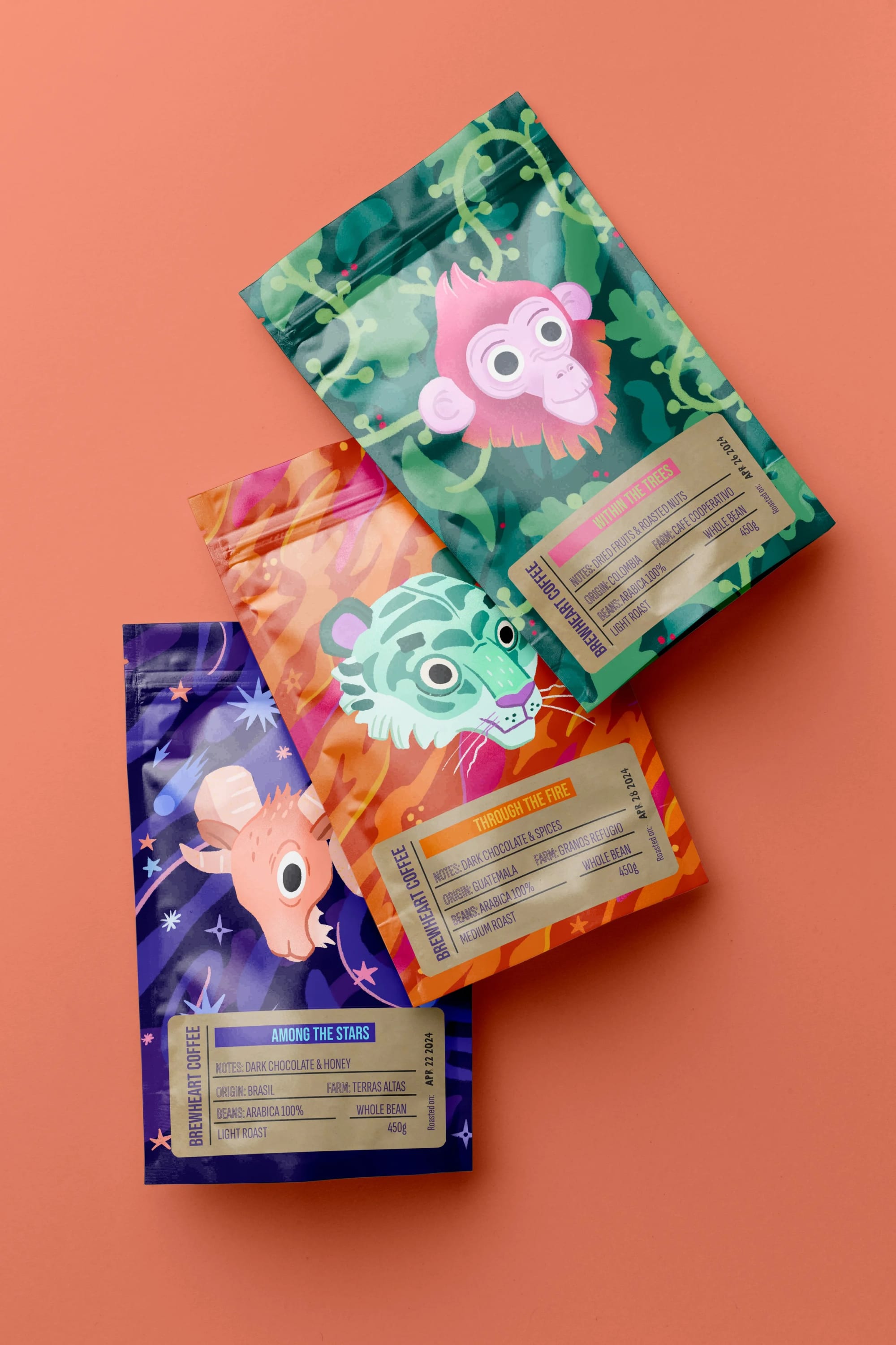 Three colorful coffee bags with animal illustrations on a pink background.