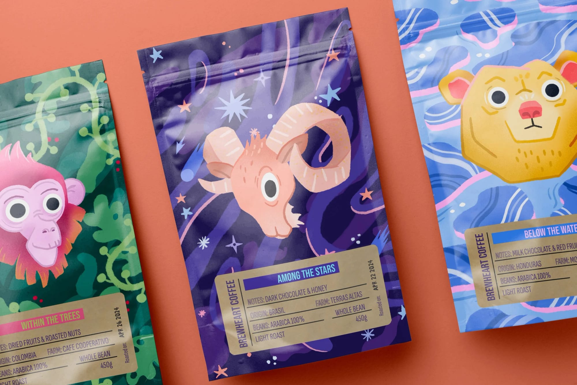 Three colorful coffee bags with animal illustrations on a pink background. The middle bag features a cartoon goat with starry space background, the left bag shows a pink monkey, and the right bag has a lion's face with a blue wavy background.
