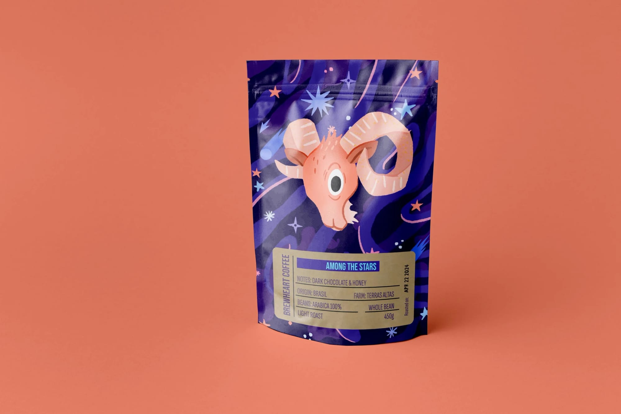 A bag of coffee with a space-themed illustration of a goat with large curved horns, surrounded by stars and cosmic elements, labeled 'Among the Stars' coffee from Brenhearth Coffee, featuring notes of dark chocolate and honey, origin Brazil, farm Terras Altas, 450 grams.