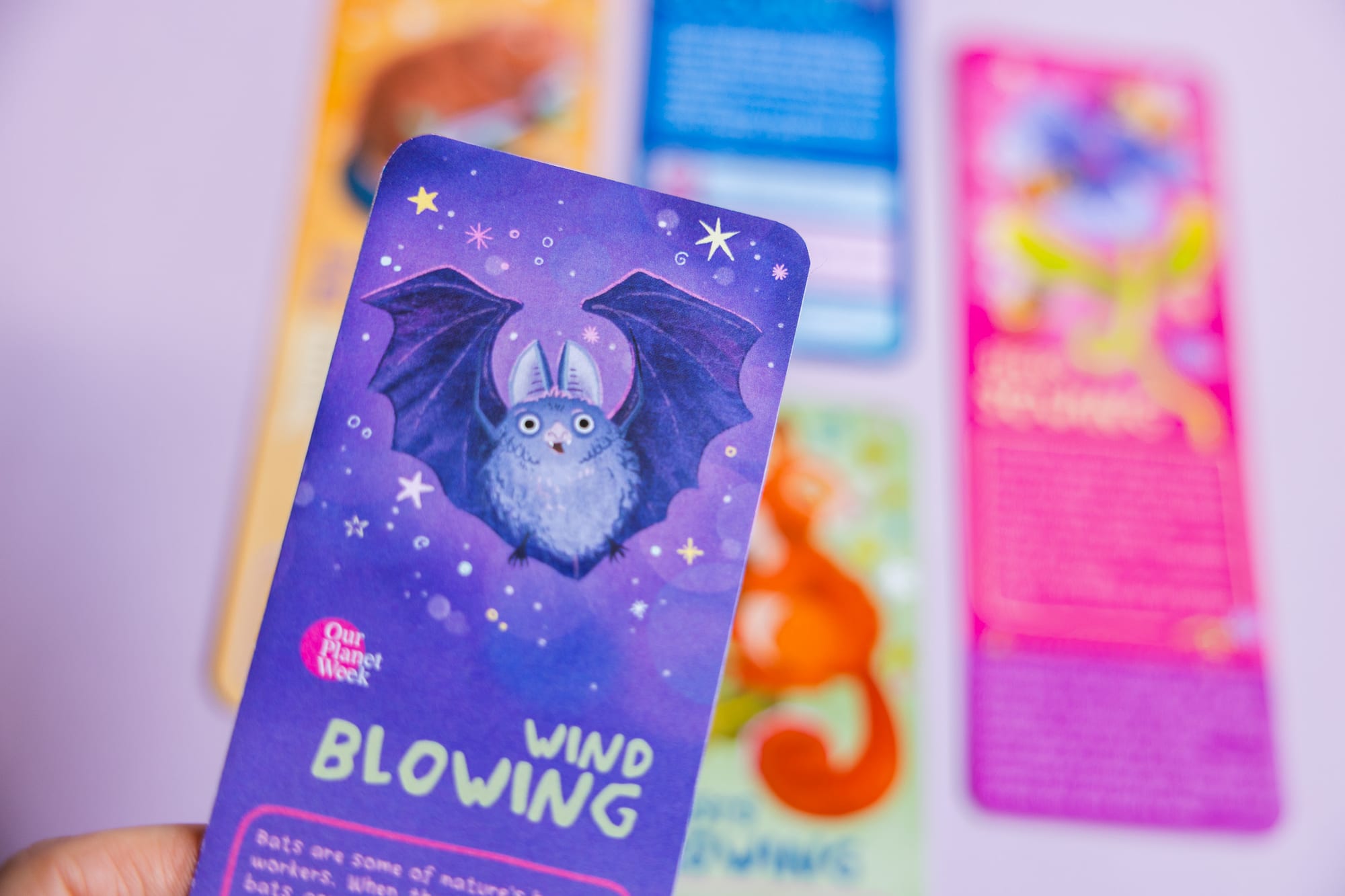 Full set of educational bookmarks fanned out, Forests Growing, Rivers Flowing, Oceans Glowing, Wind Blowing, Seeds Sowing.