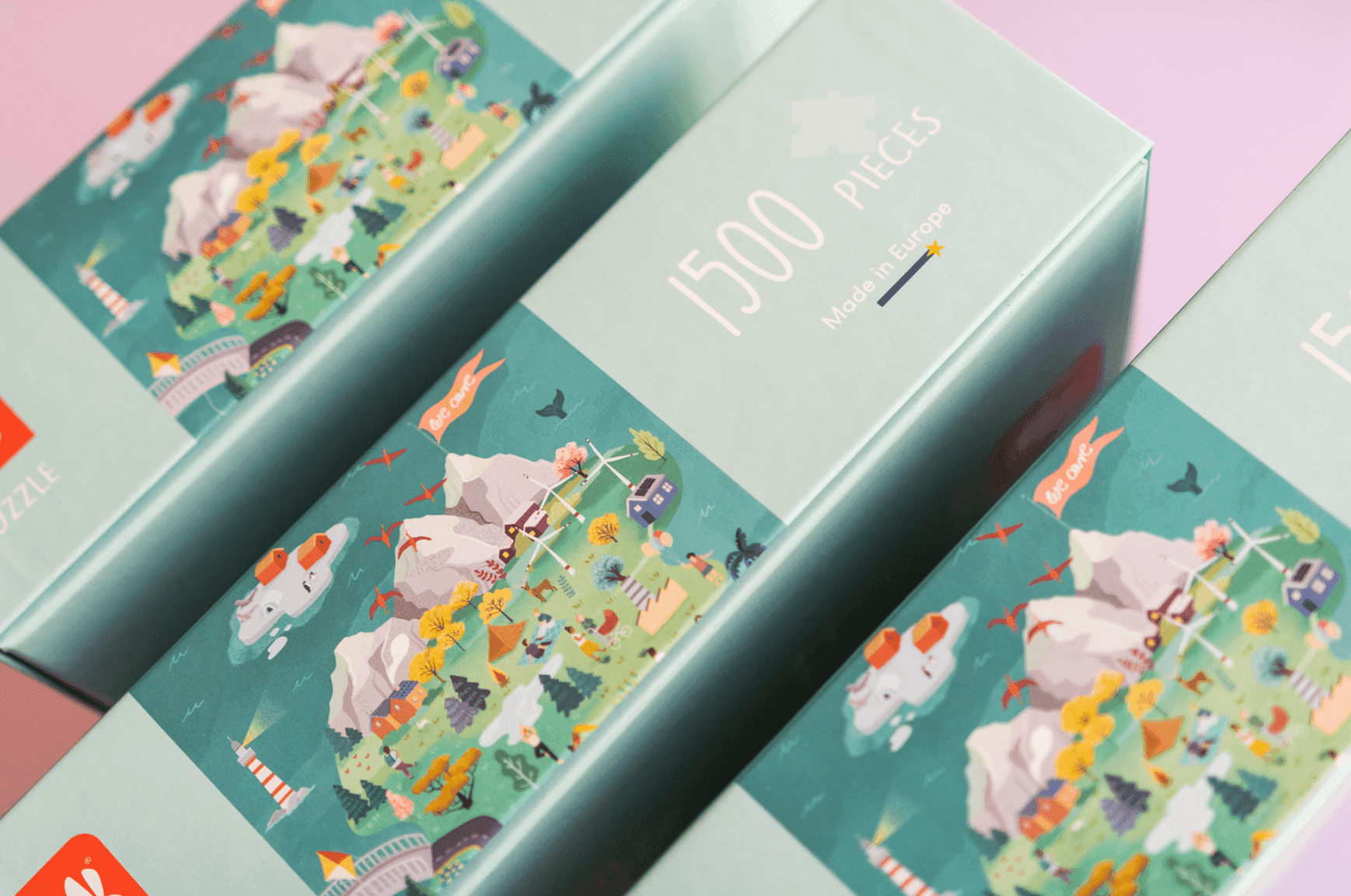 Boxes of 1500-piece puzzles with illustrated scenic landscapes of mountains, wind turbines, lakes, and forests in a colorful, cartoon style. The packaging indicates they are made in Europe.