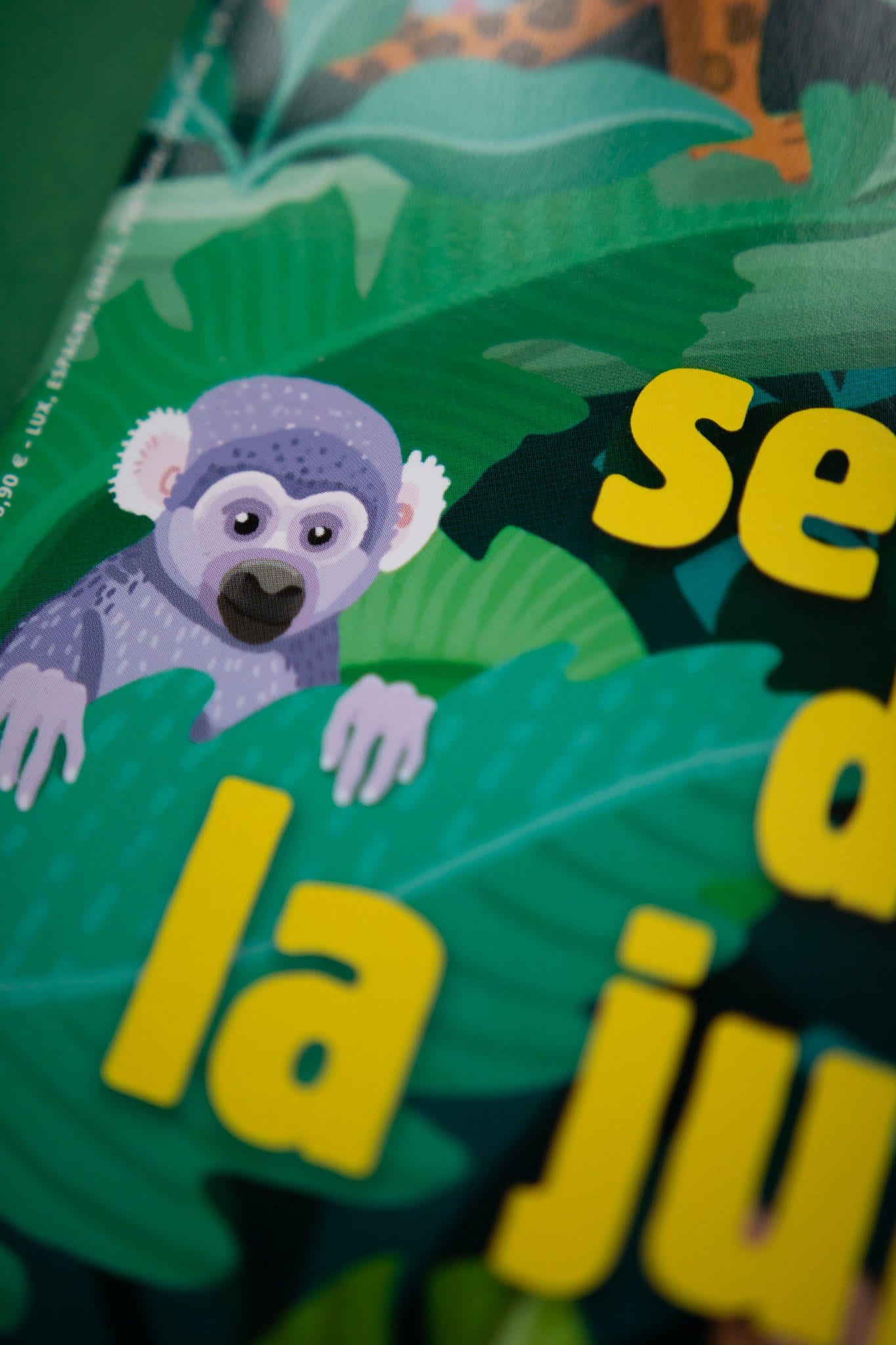 Editorial magazine cover detail with foliage and creatures.