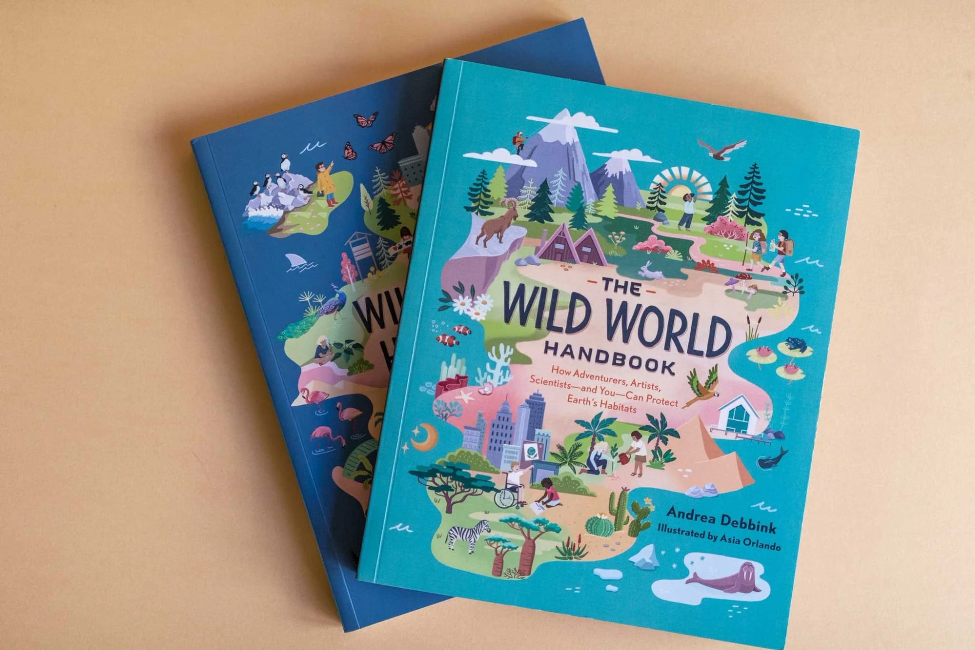 Illustrated children's books titled "The Wild World Handbook" by Andrea Debbink, featuring colorful nature and outdoor scenes on the covers.